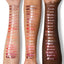 Arm swatch on three skin tones showing all shades of MoistureGlow™ Plumping Lip Serum.